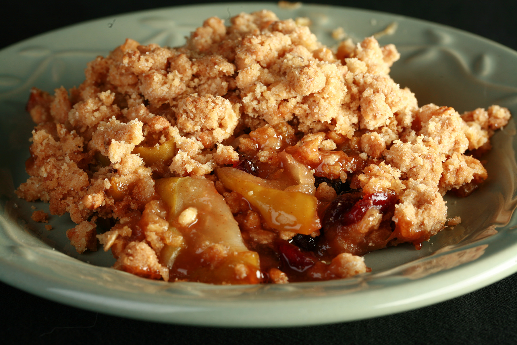 A plate with a generous serving of gluten-free Brandied Apple Crisp.