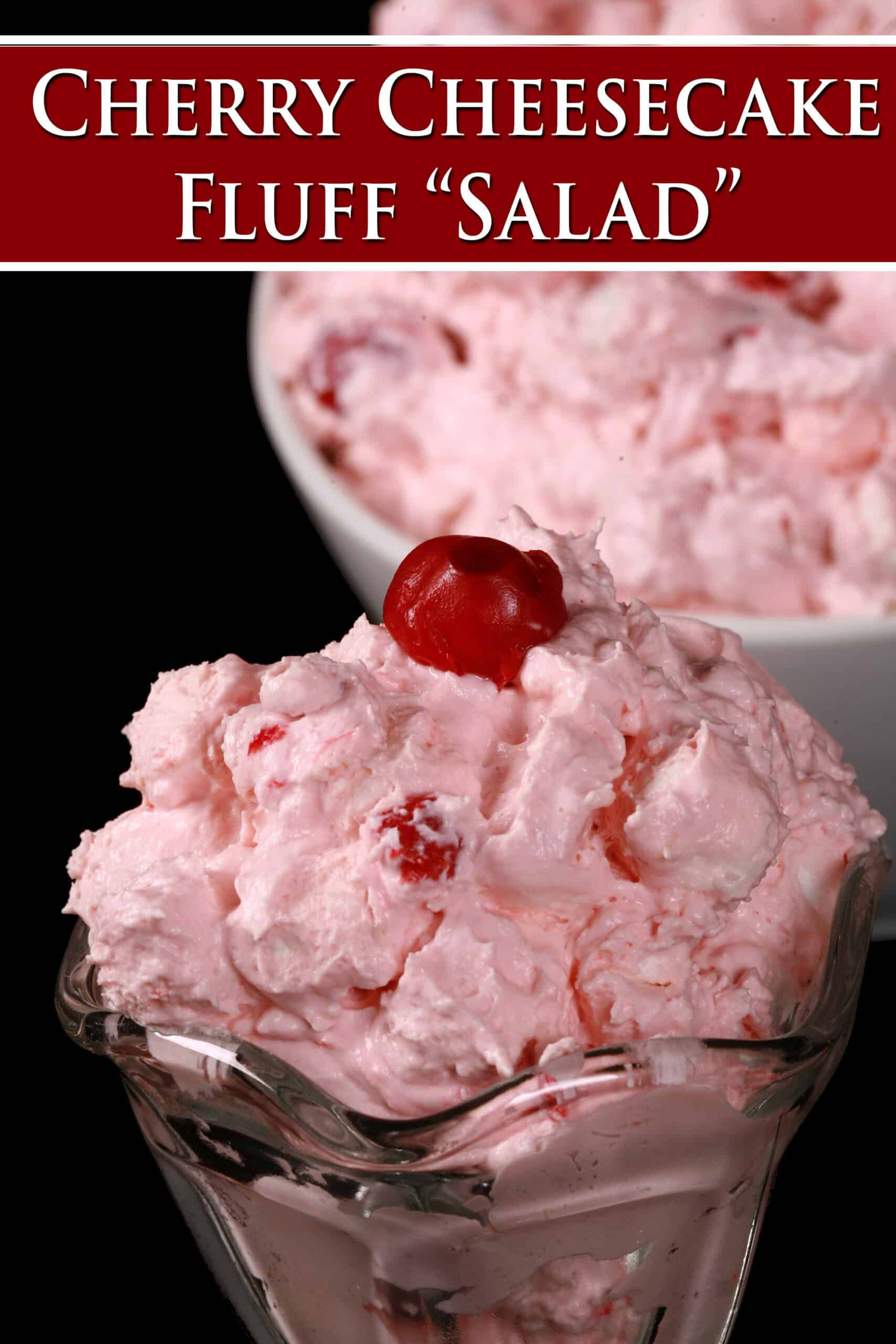 A serving glass of cherry fluff salad, in front of a bowl of it. Overlaid text says cherry cheesecake fluff salad.