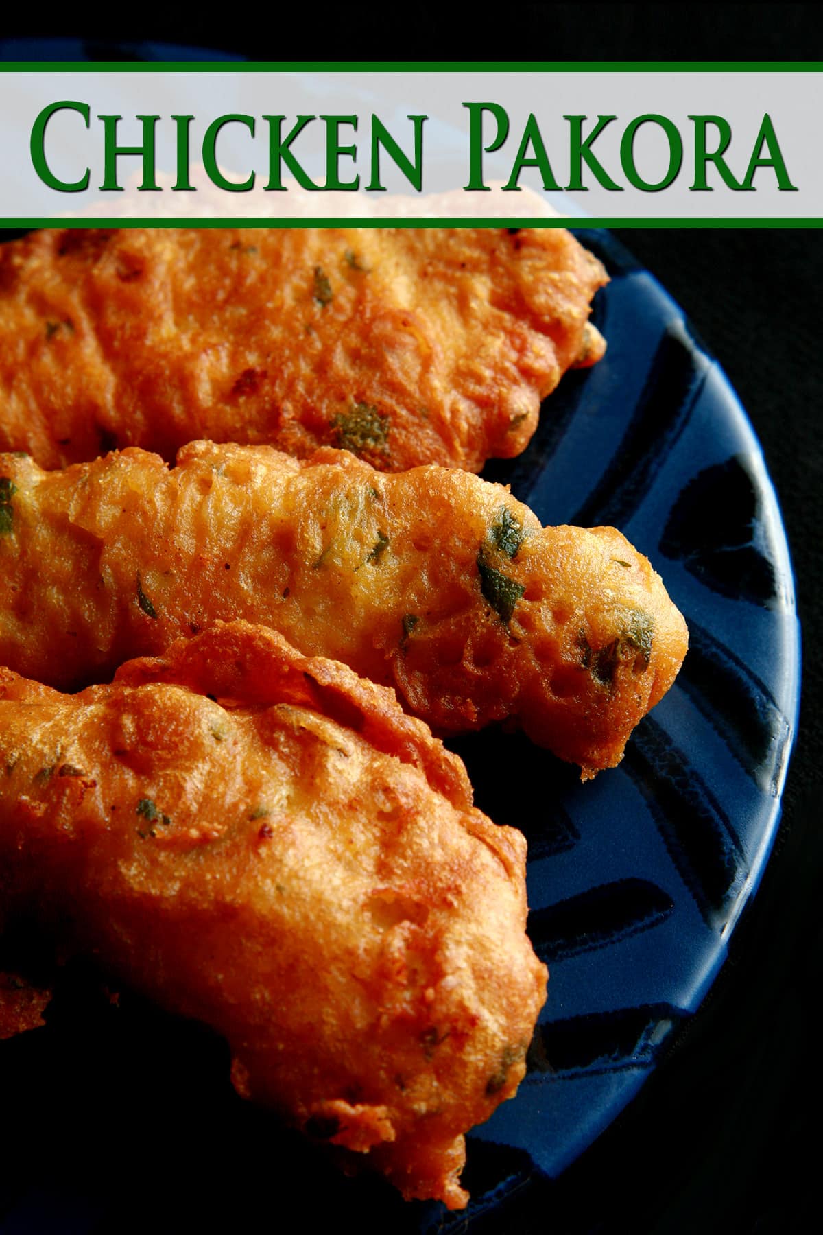 Several chicken pakora strips on a blue plate.