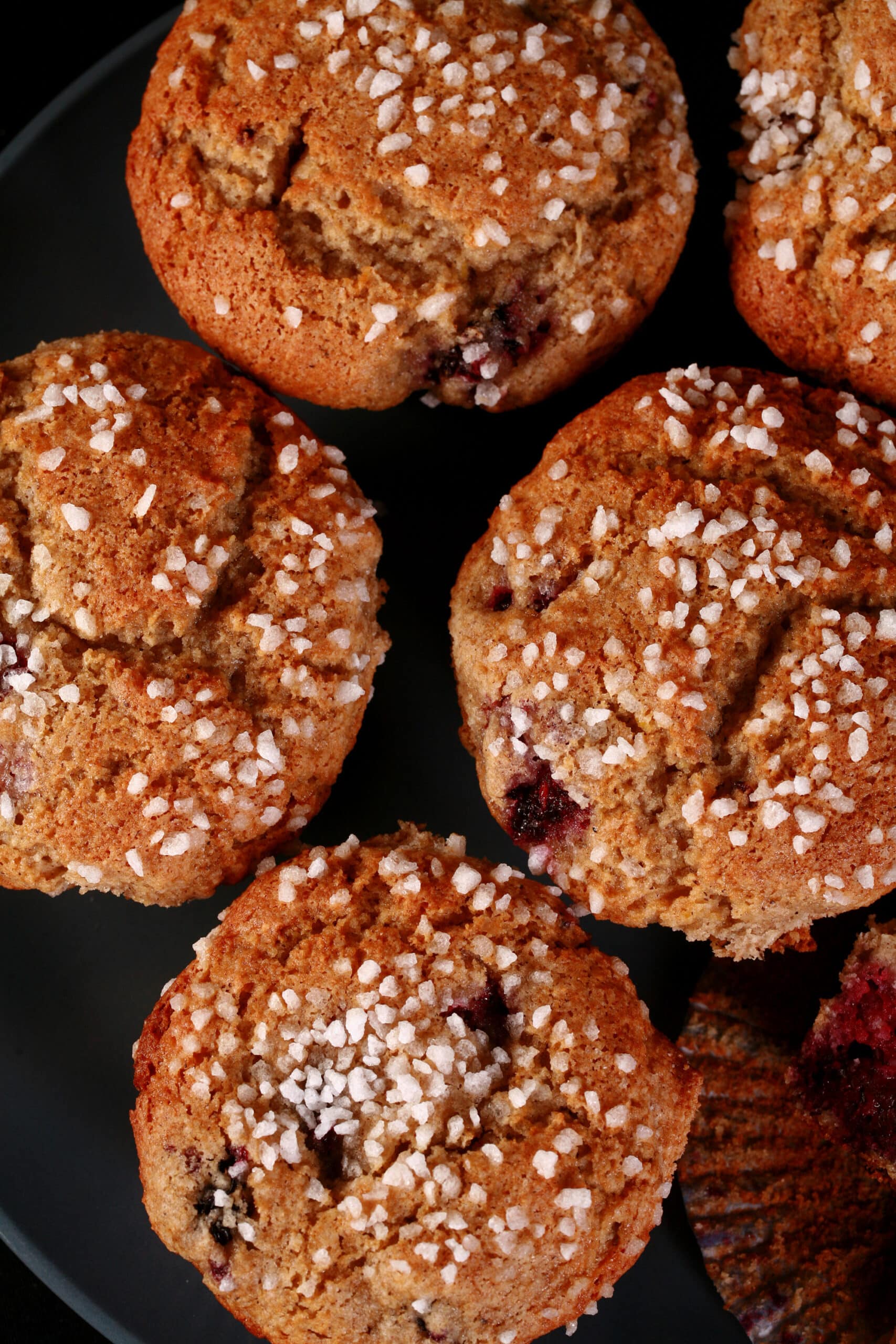 A plate of sugar crusted gluten-free blackberry muffins.
