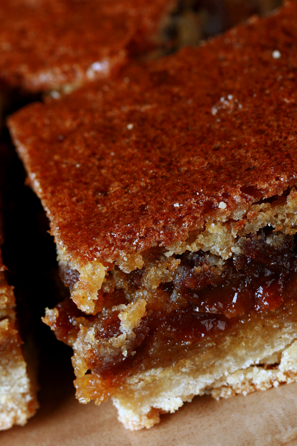 Close up view of a plate of gluten free butter tart squares.