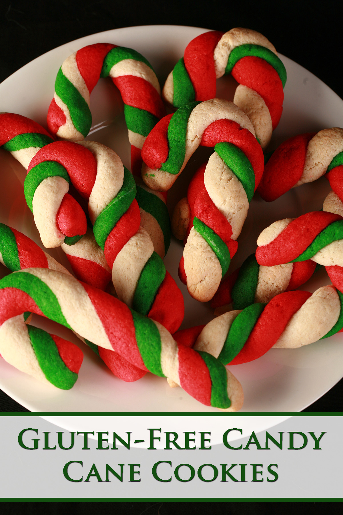 Gluten-Free Candy Cane cookies - candy cane shaped cookies, made from lengths of red, green, and white twisted dough - on a plate.