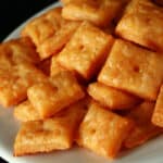 A plate of gluten free cheez its cheese crackers.