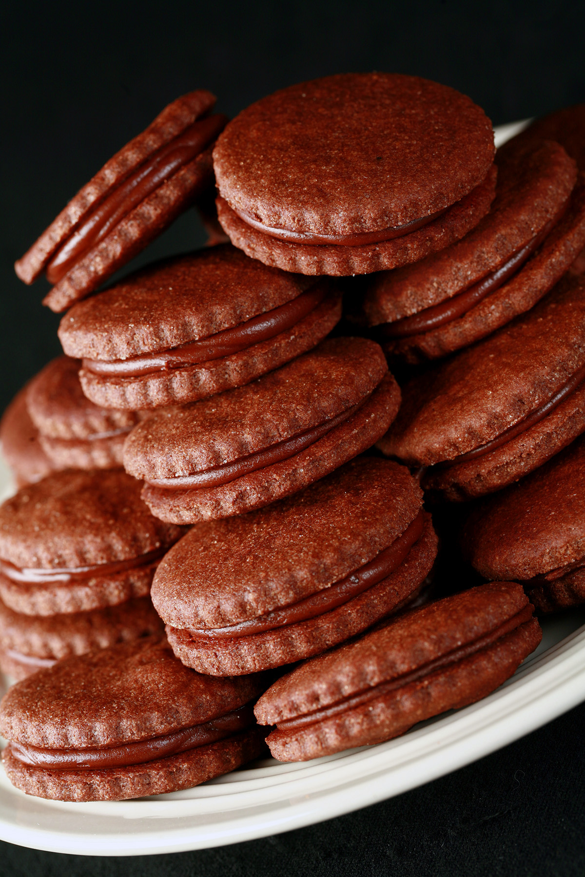 A plate of gluten free chocolate sandwich cookies.