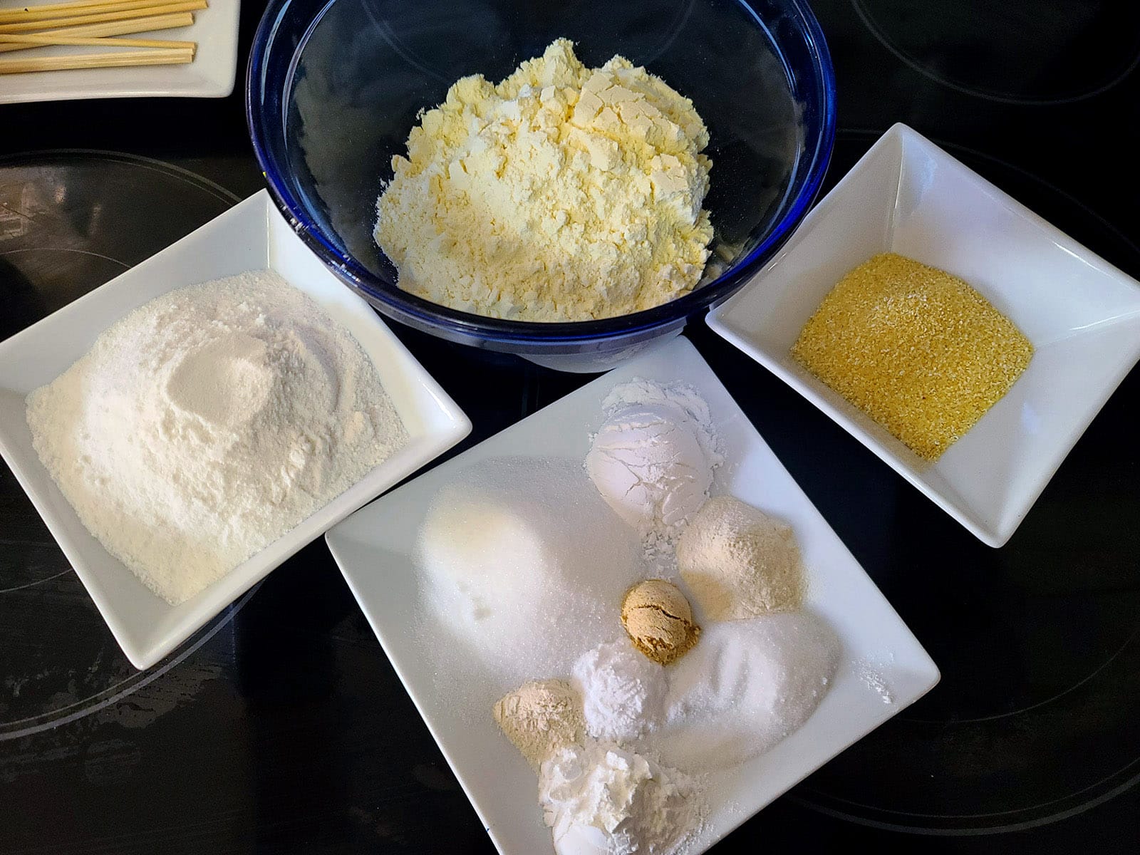 All of the dry ingredients in bowls.