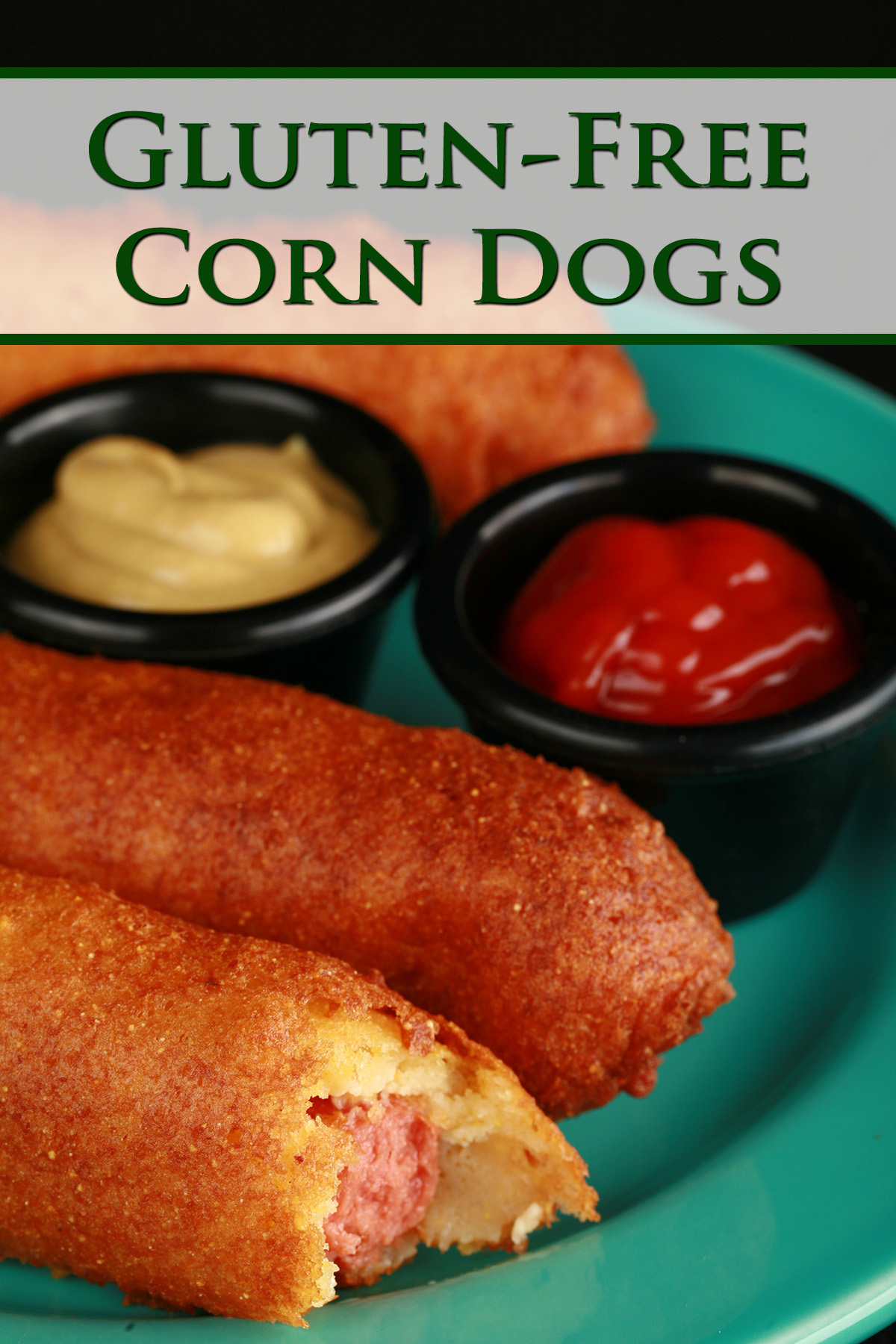 3 gluten-free corndogs on a green plate, with little bowls of ketchup and mustard.
