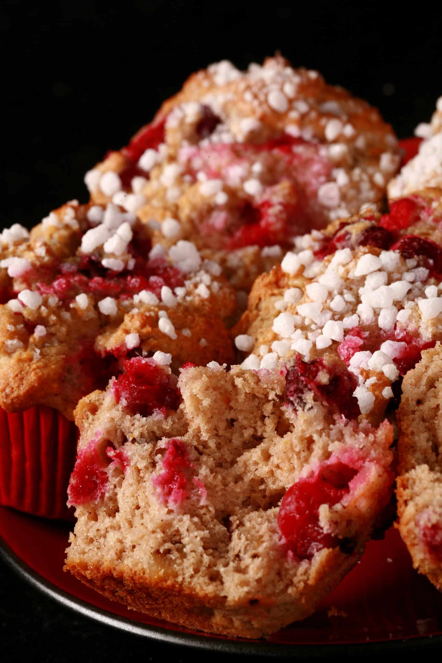 1 plate of gluten-free cranberry walnut muffins with sugar crust on top.