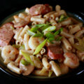 A plate of gluten-Free Creamy Creole Pasta. Shrimp, chicken, sausage, and celery are visible.