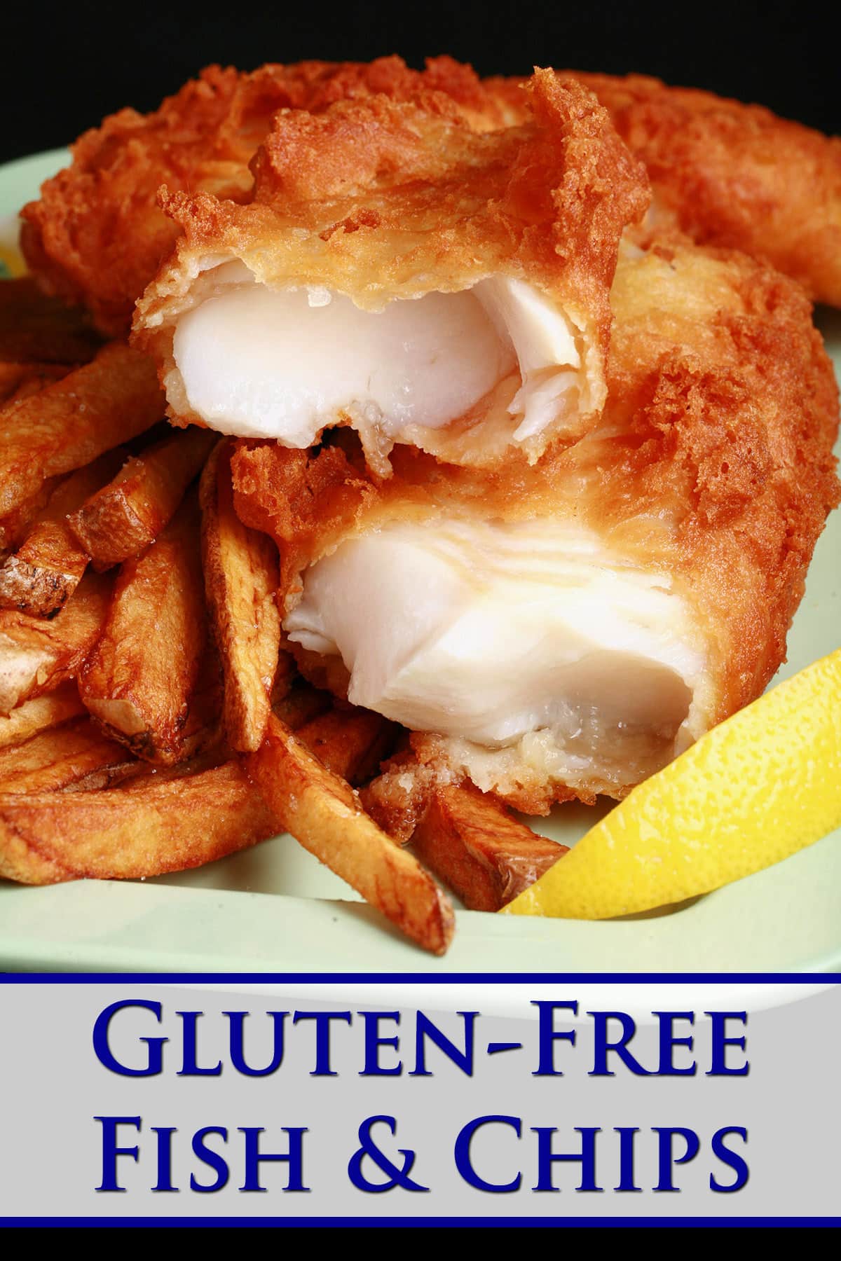 A plate of gluten free fish and chips, with a wedge of lemon.