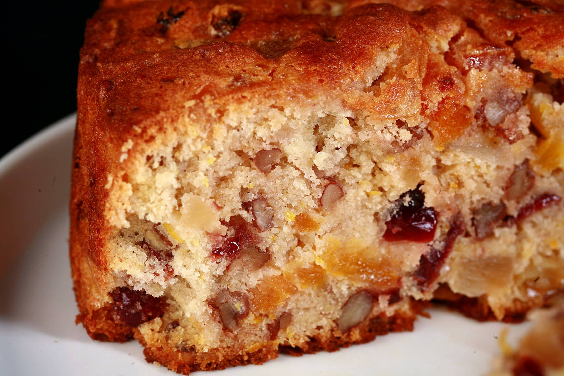 A sliced up gluten free fruit cake.