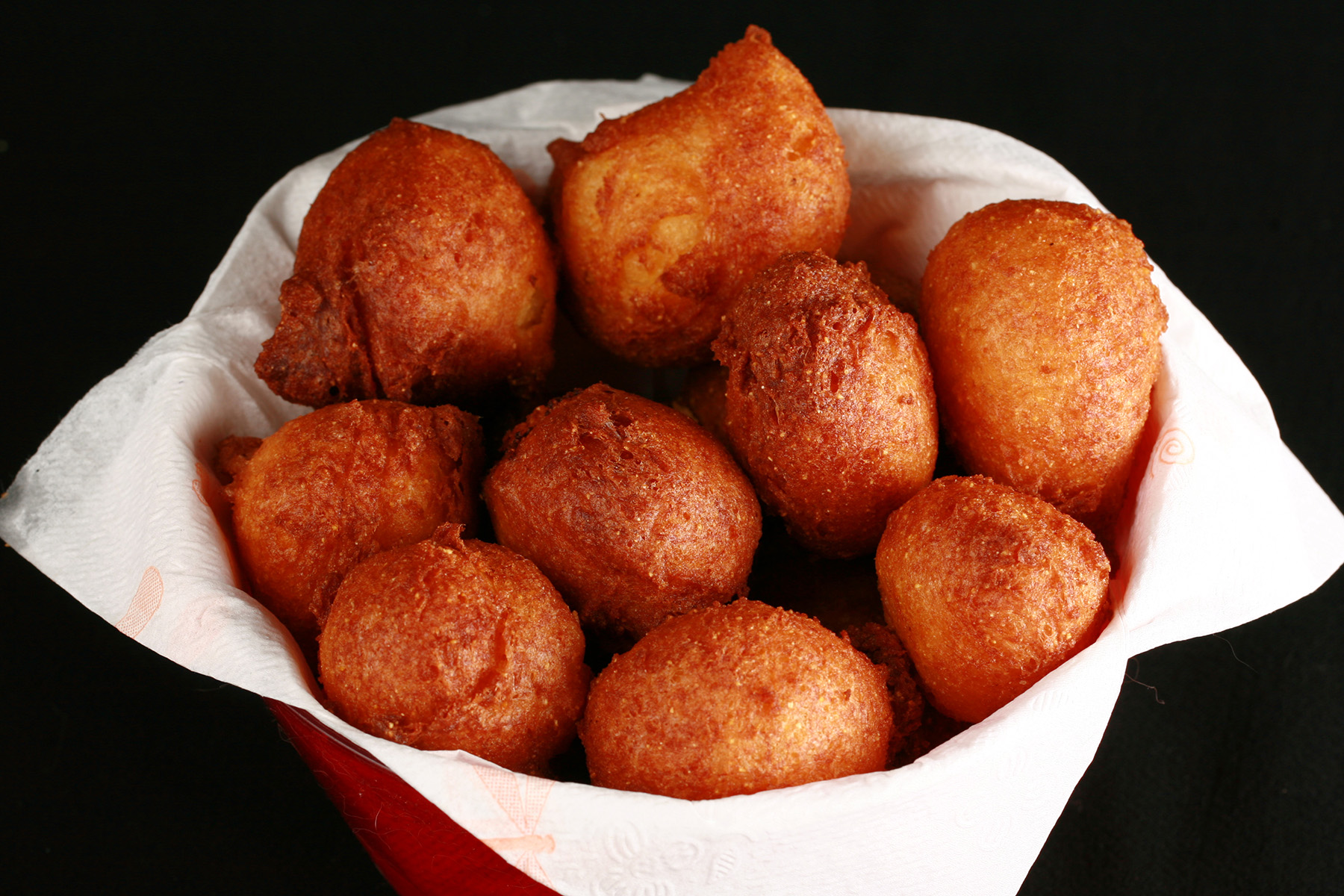 A bowl of gluten-free hush puppies - little balls of deep fried cornmeal dough.
