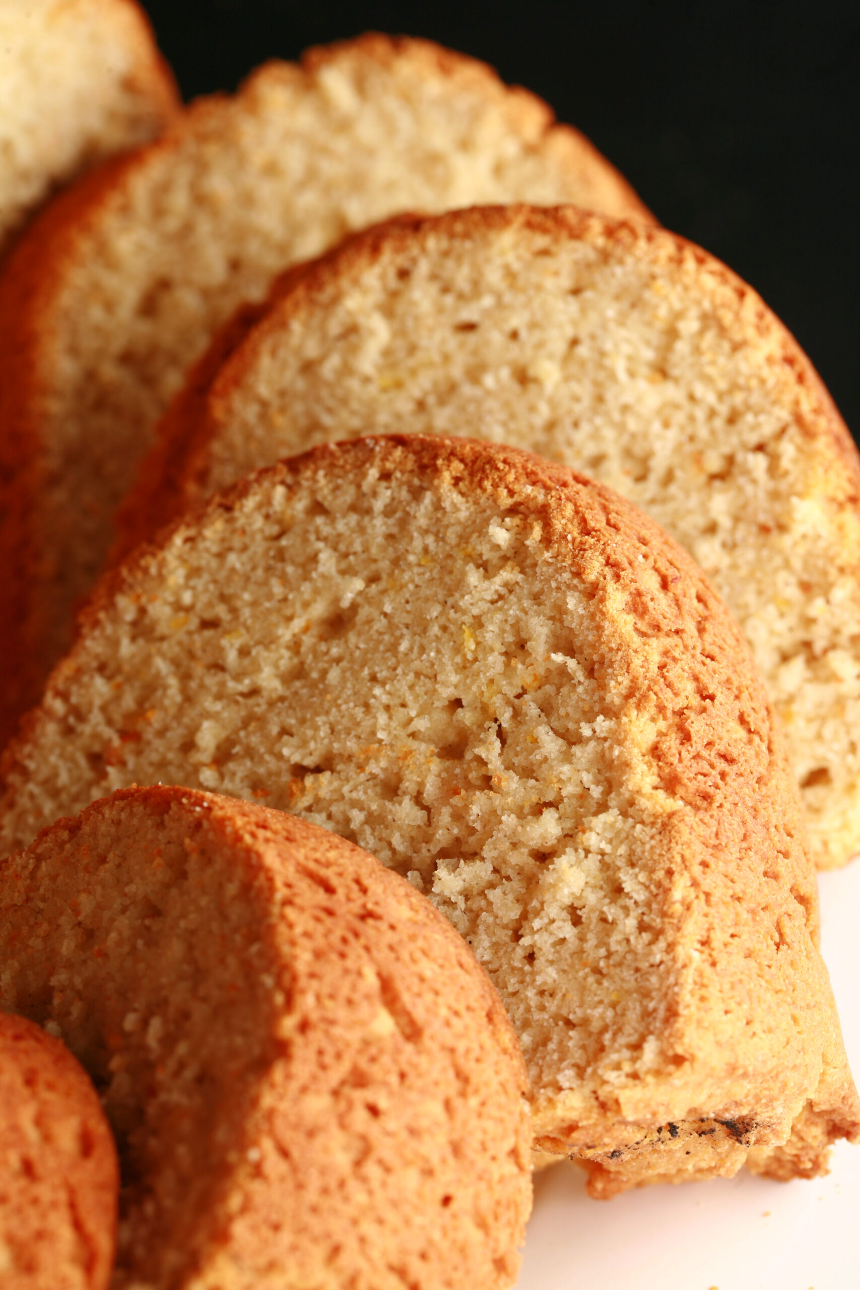 Sliced of a pale yellow bundt shaped loaf of bread.