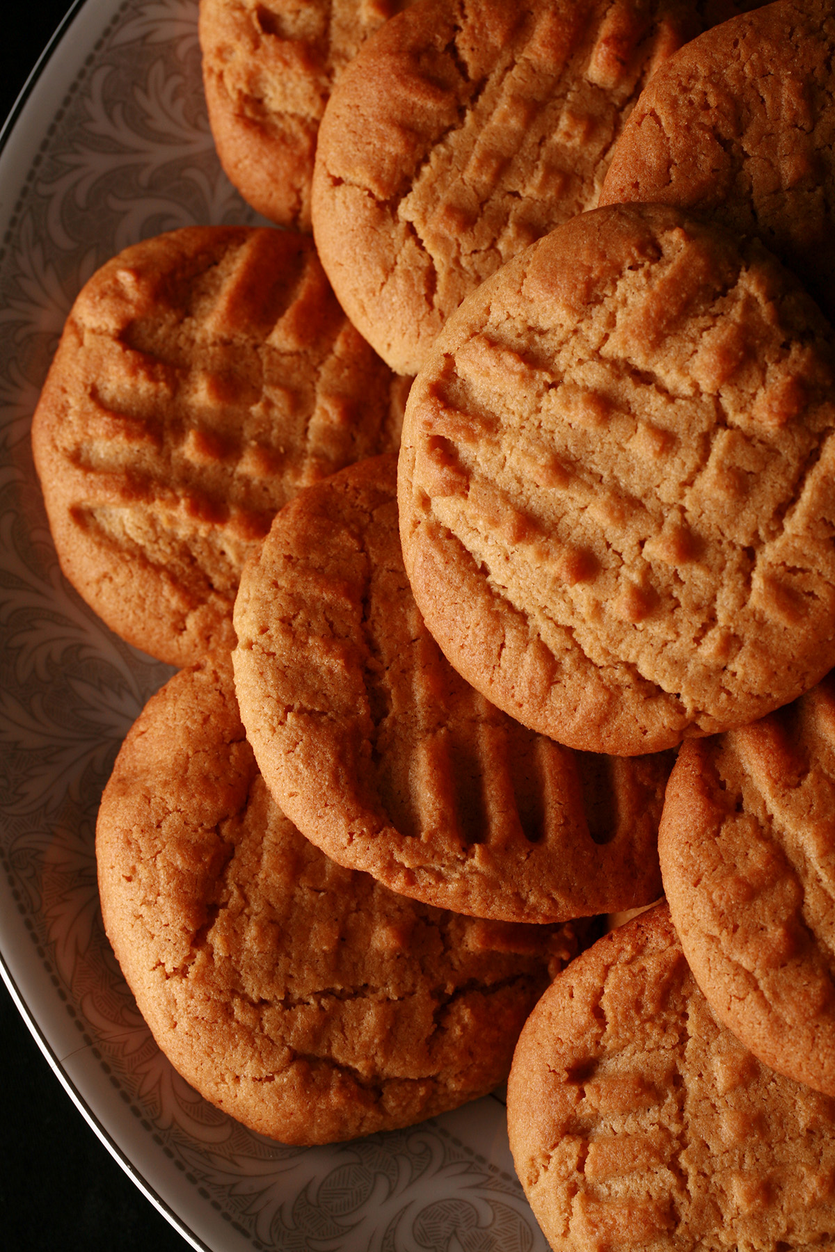 A plate of soft and chewy gluten-free peanut butter cookies.