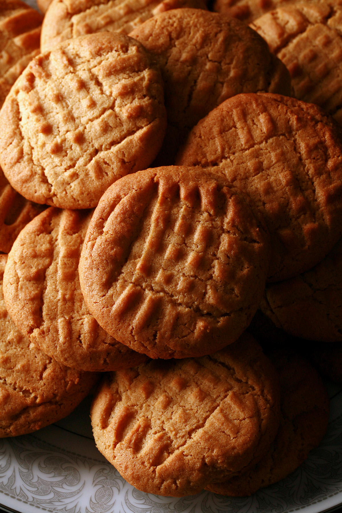 A plate of soft and chewy gluten-free peanut butter cookies.