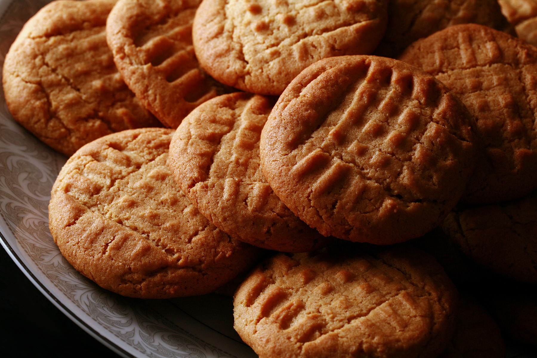 A plate of soft and chewy gluten-free peanut butter cookies.