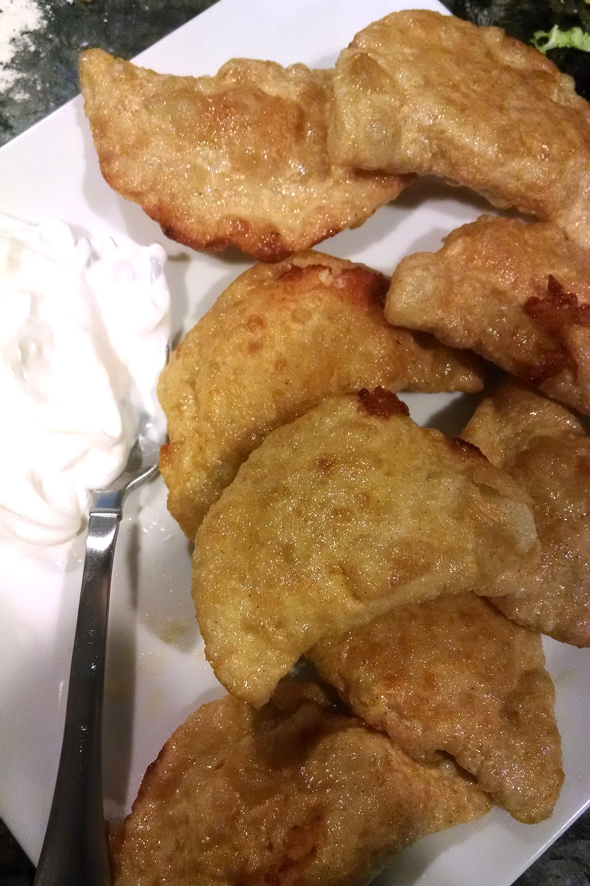 A plate of deep fried gluten-free pierogi.