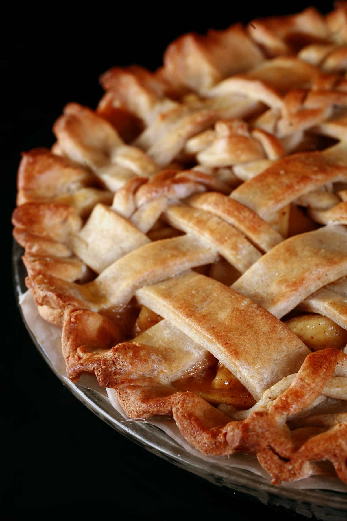 A close up view of a lattice topped pie, made with a gluten-free pie crust.
