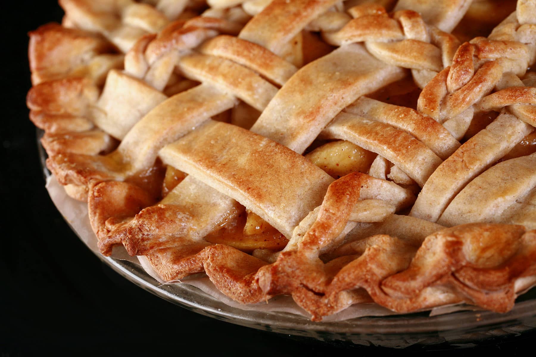 A close up view of a lattice topped pie, made with a gluten free pie crust.