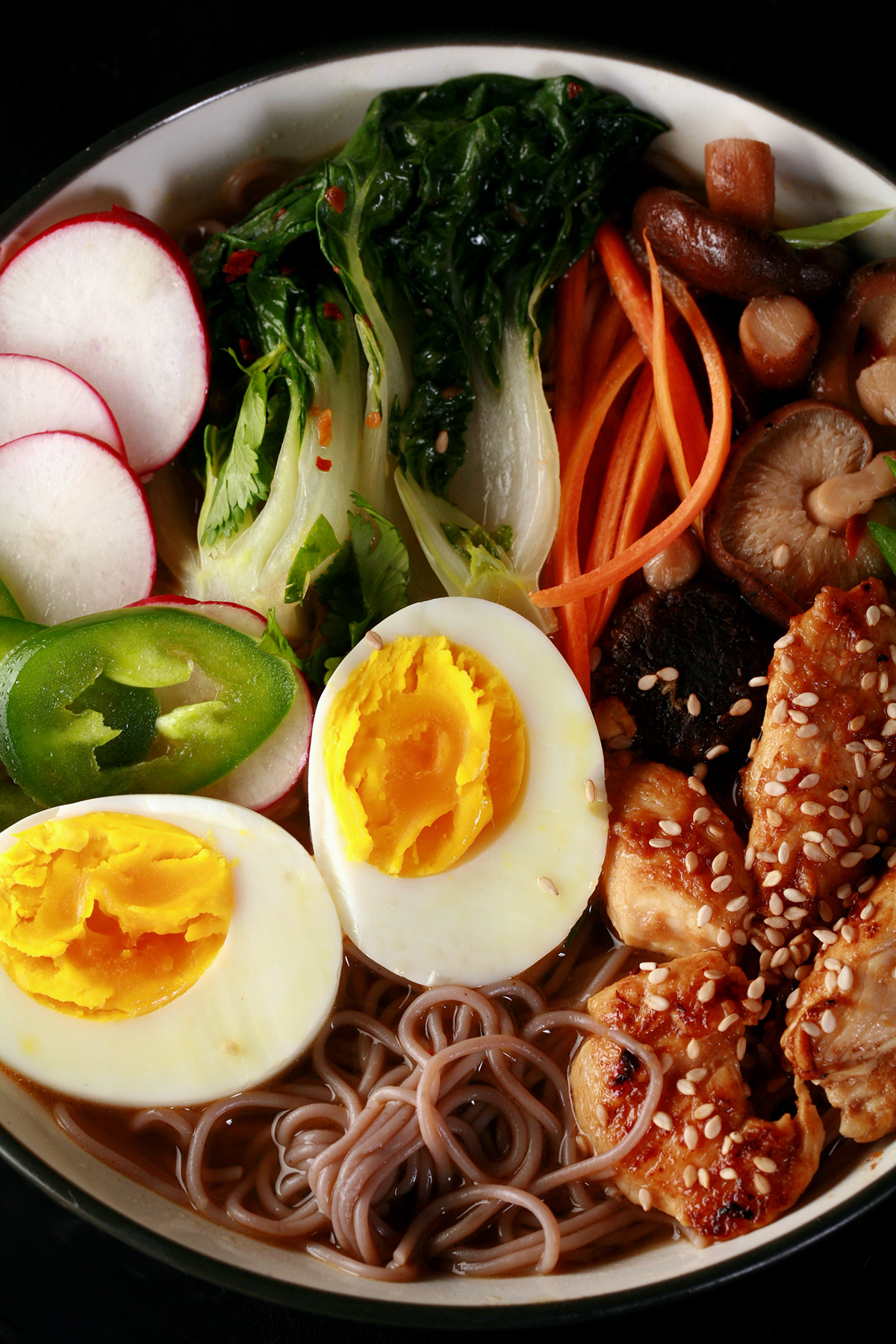 A bowl of gluten-free ramen, with chicken and vegetables.