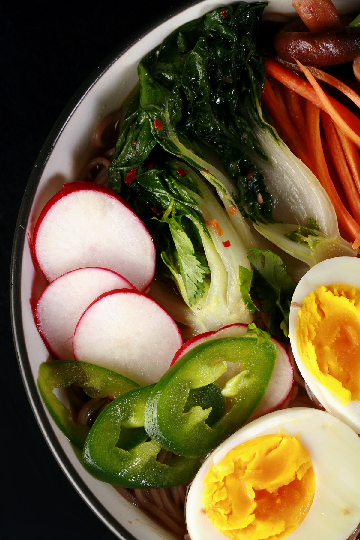 A bowl of gluten-free ramen, with chicken and vegetables.
