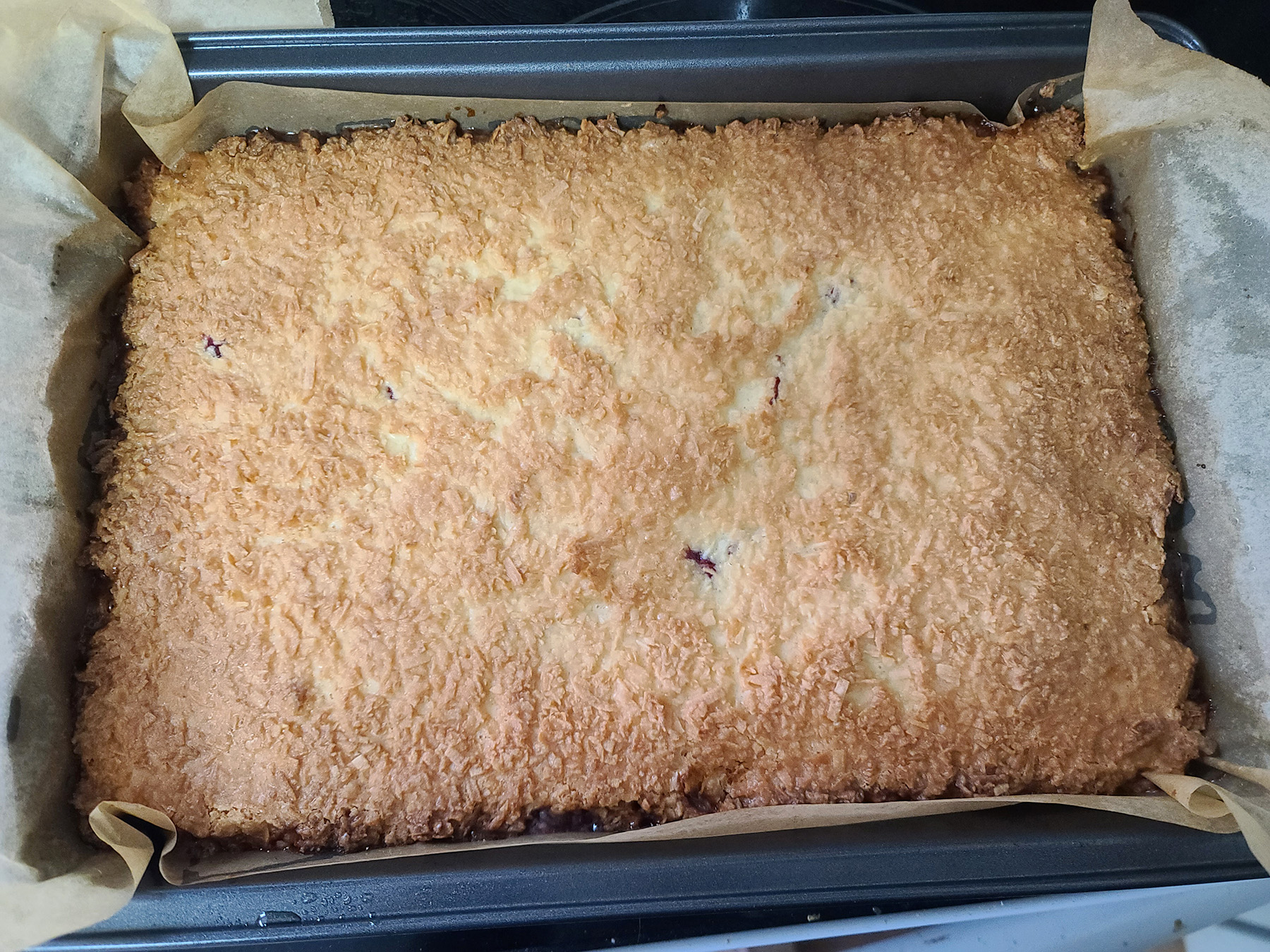 A freshly baked pan of gluten free raspberry bars.