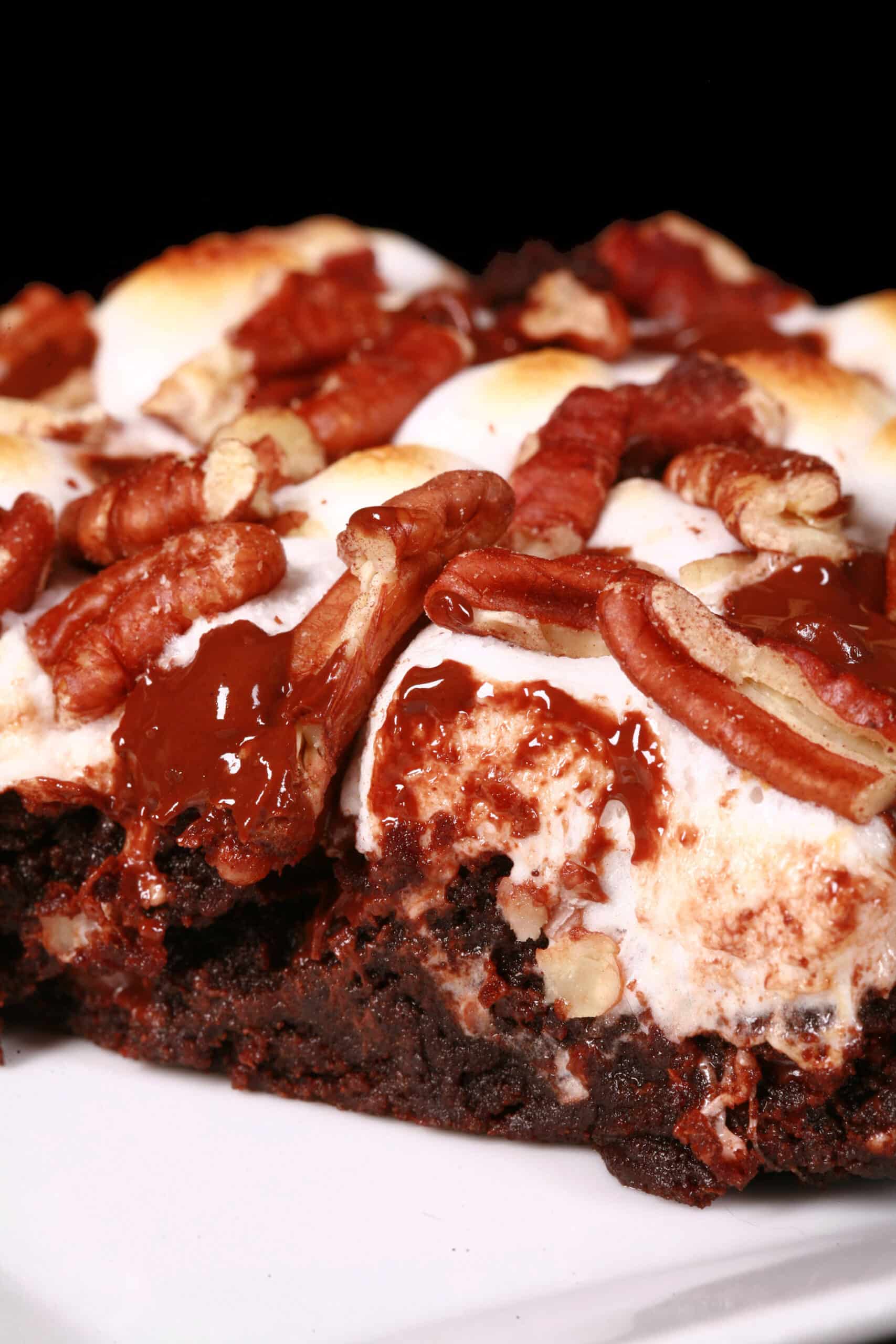 A gluten free rocky road brownie, topped with toasted mini marshmallows, pecans, and chocolate chips.
