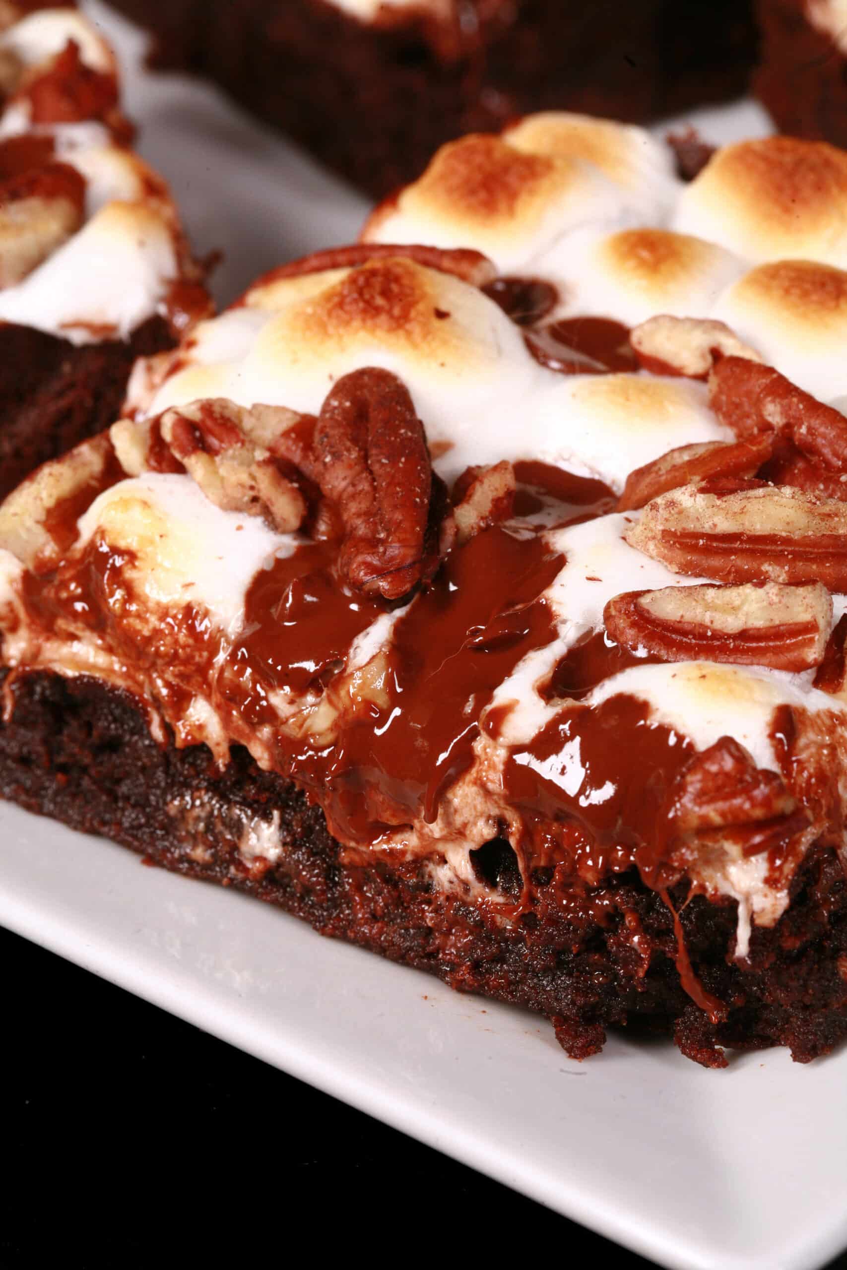 A gluten-free rocky road brownie, topped with toasted mini marshmallows, pecans, and chocolate chips.