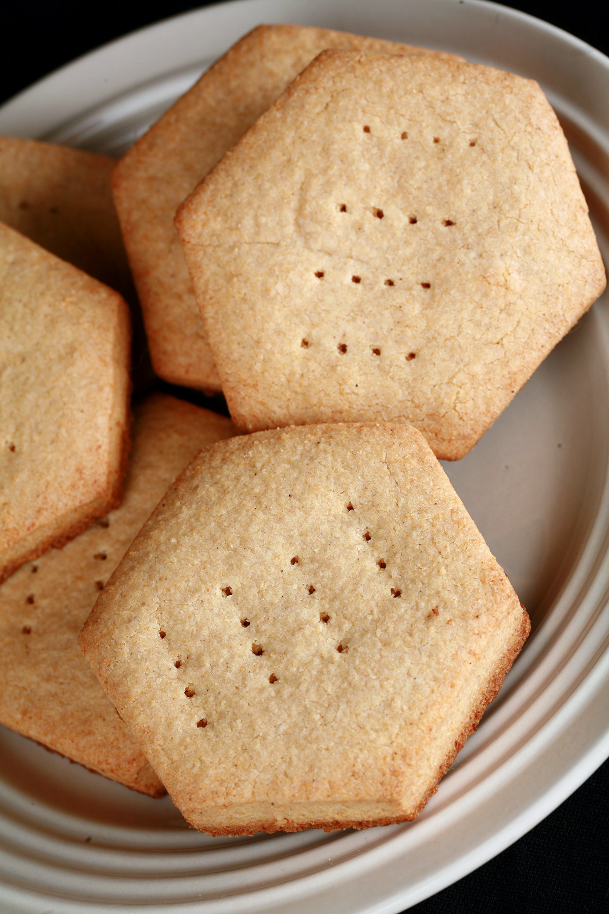 A plate of hexagonal gluten free shortbread cookies.