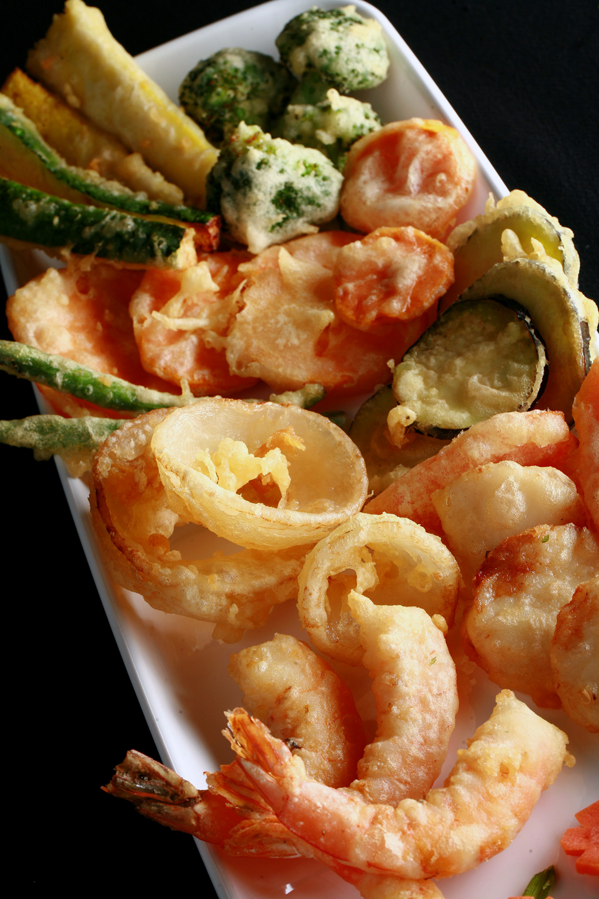 A tray of gluten-free tempura shrimp and vegetables.