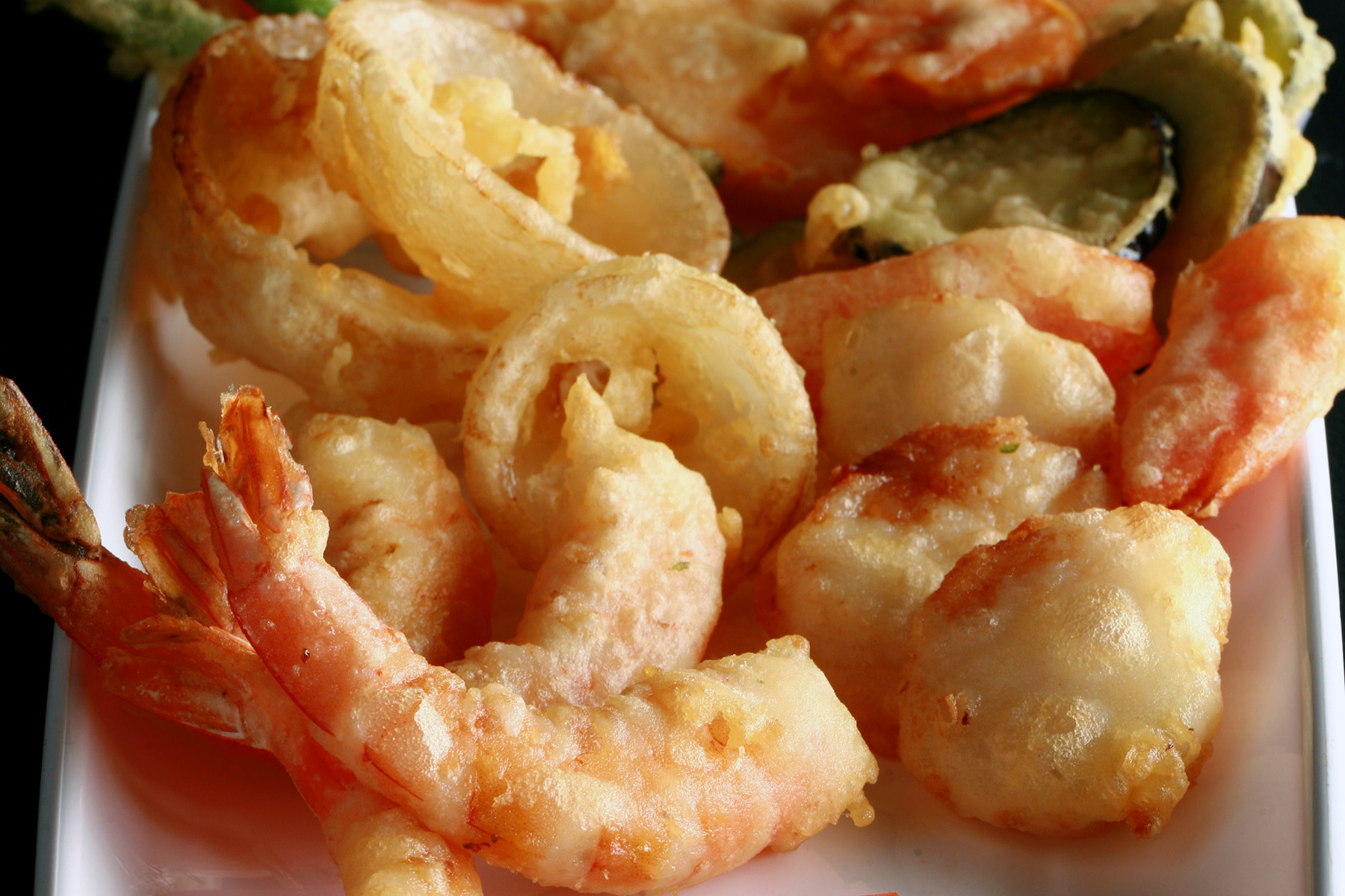 A tray of gluten free tempura shrimp and vegetables.