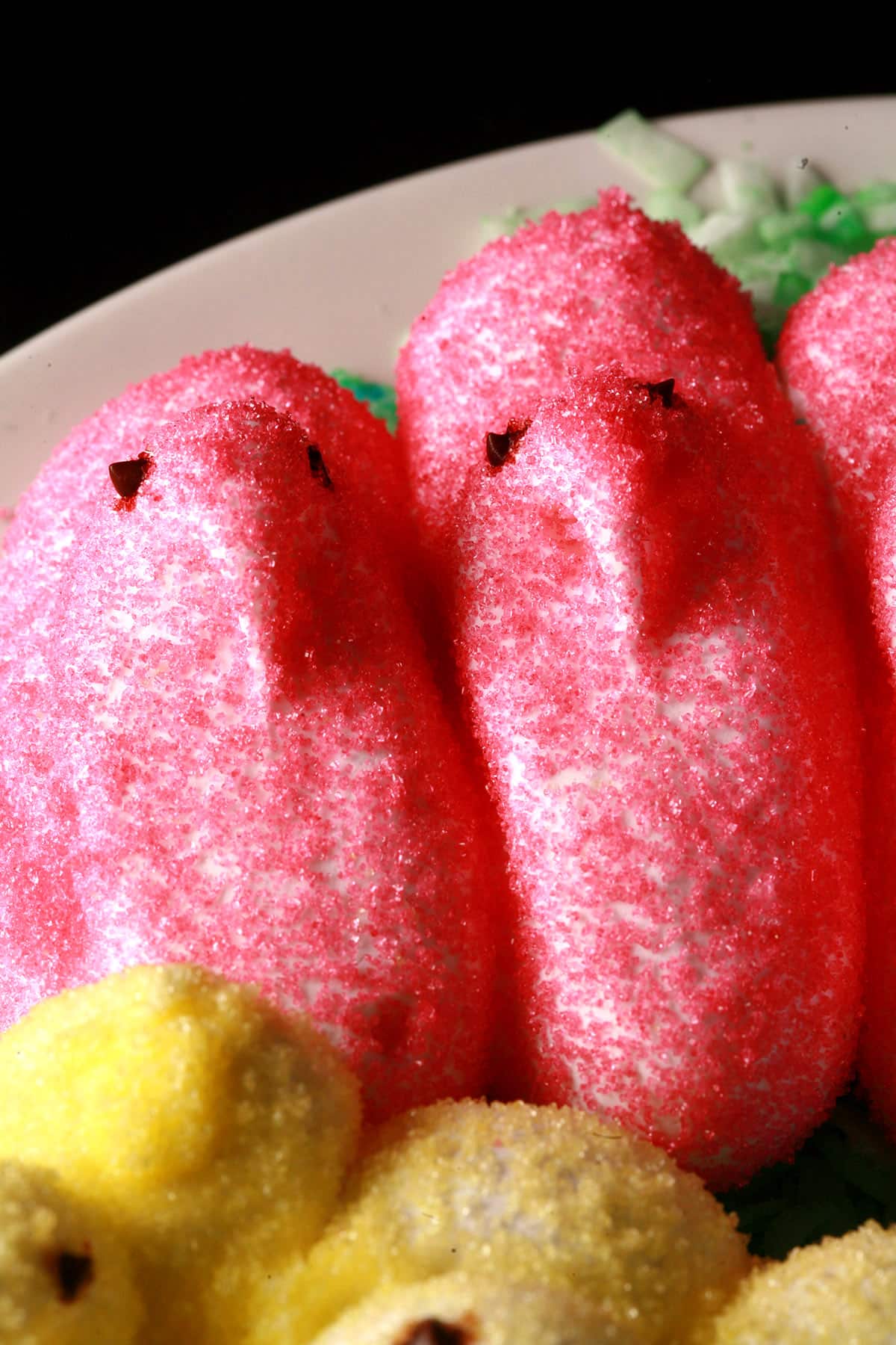Pink homemade marshmallow peeps on a plate.