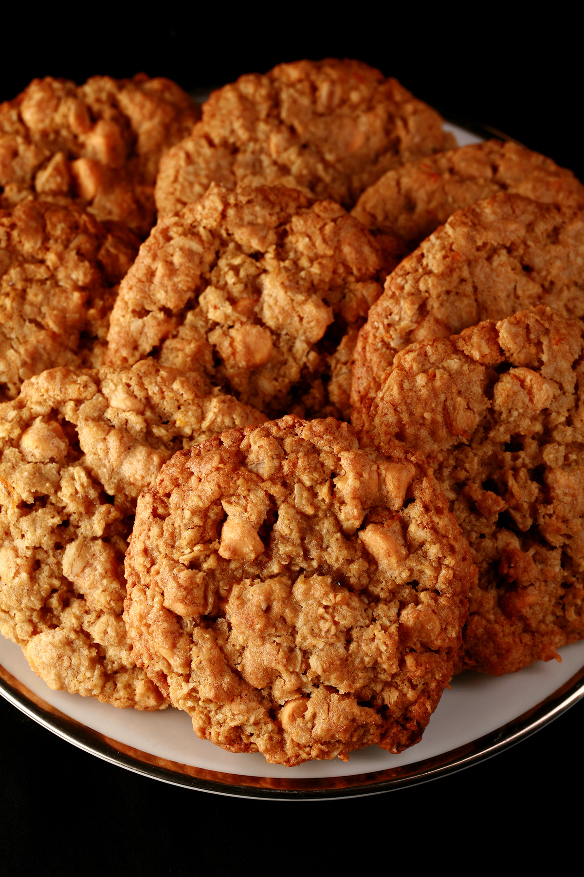Close up photo of a plate of gluten-free oatmeal cookies with visible butterscotch chips