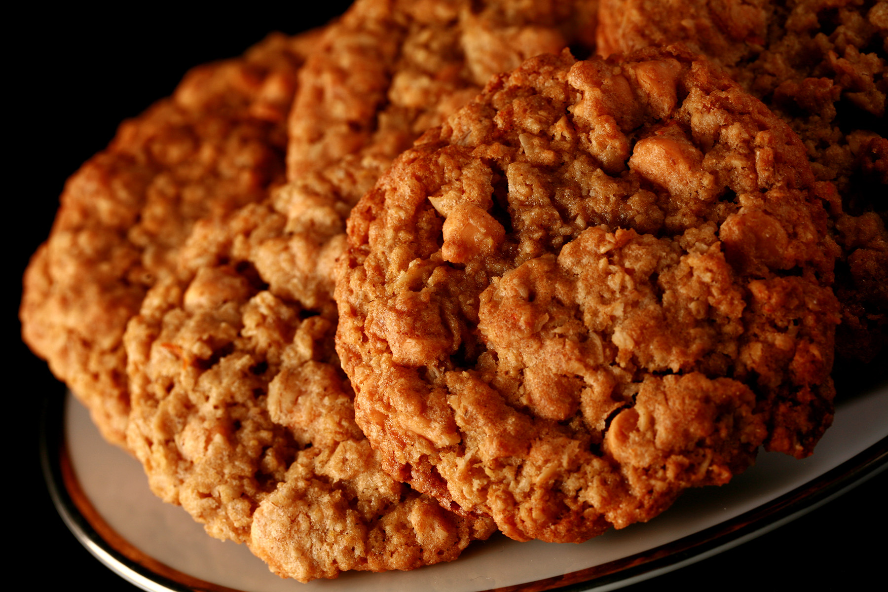 Close up photo of a plate of gluten-free oatmeal cookies with visible butterscotch chips