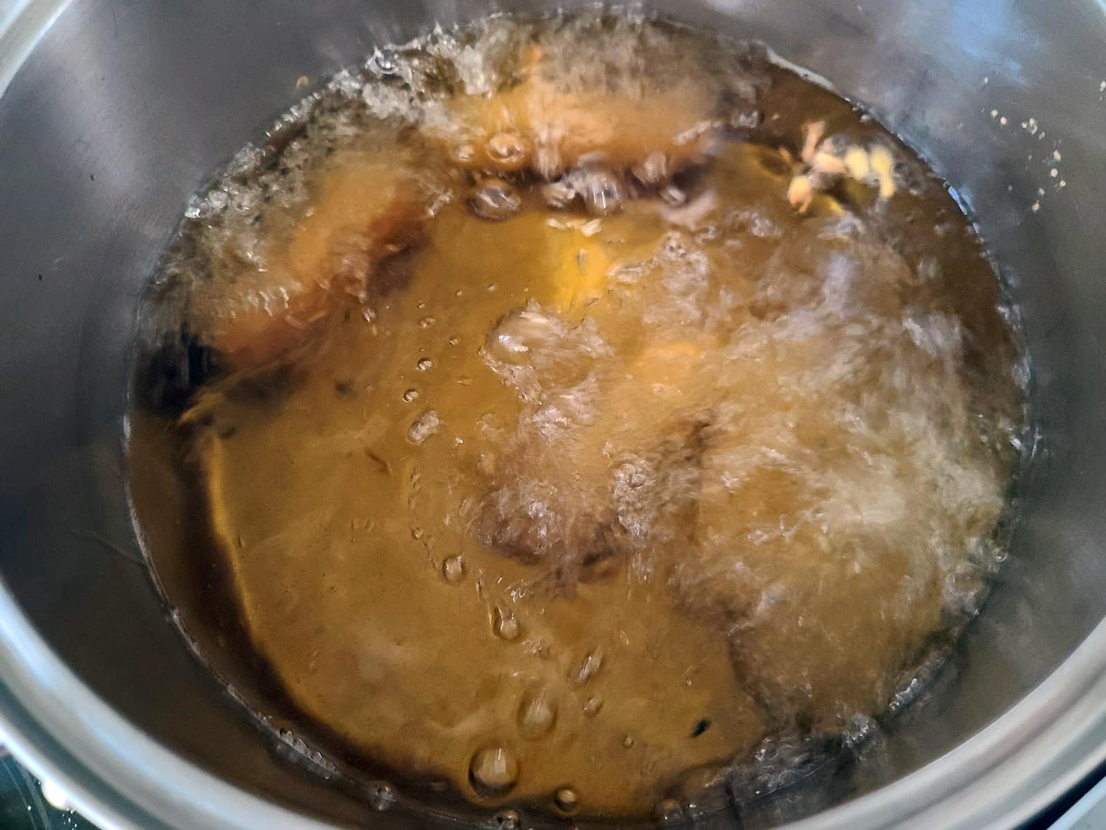 Paneer pakoras deep frying.