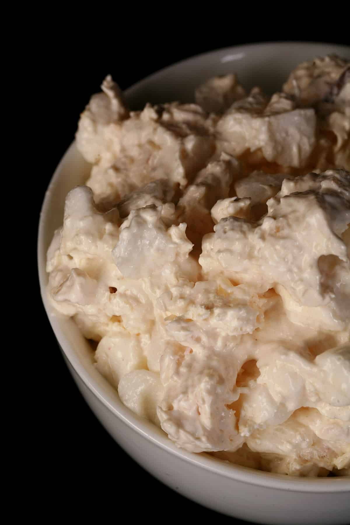 A close up photo of a serving of pina colada fluff in a tulip glass.