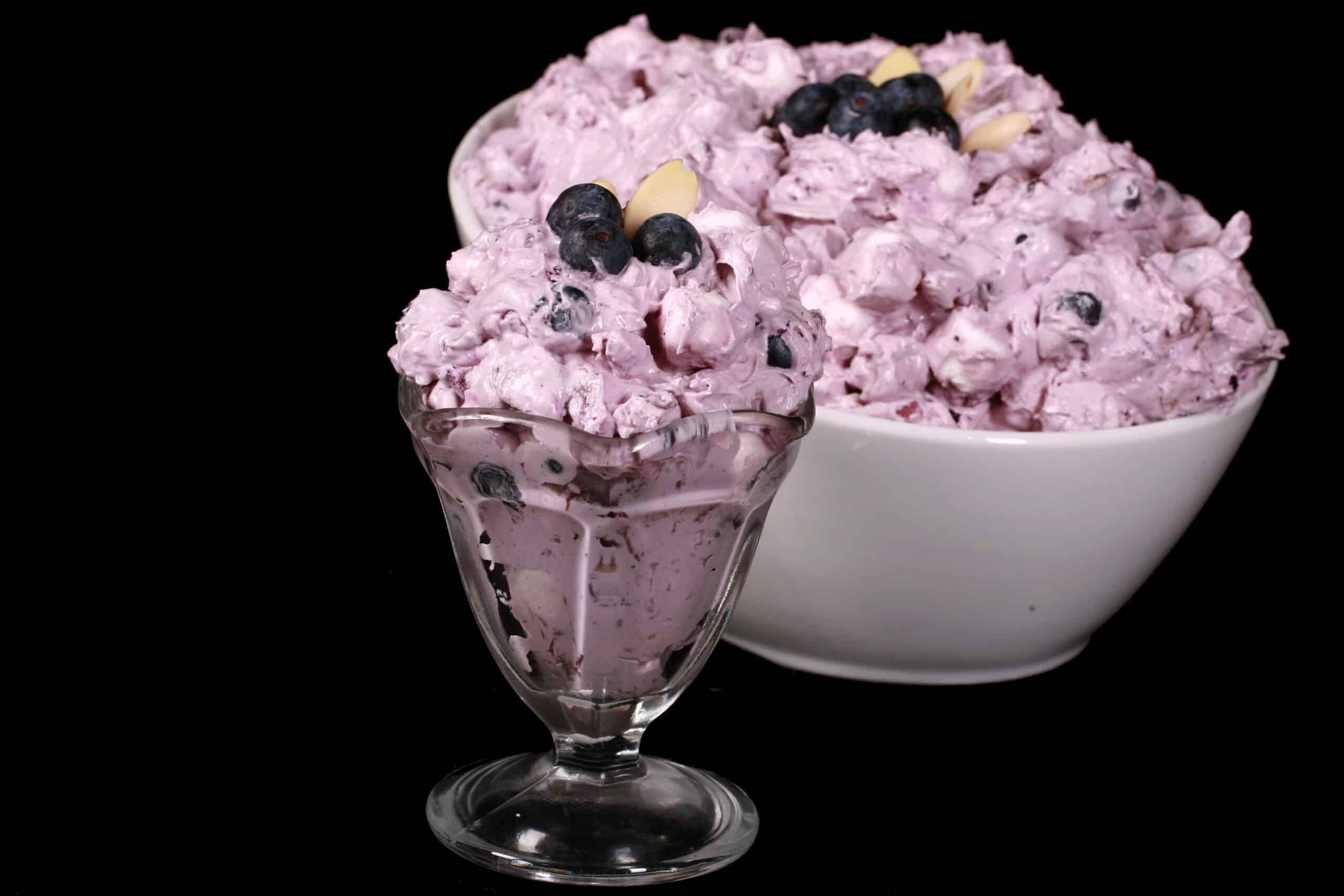 A bowl of blueberry and marshmallow fluff salad.