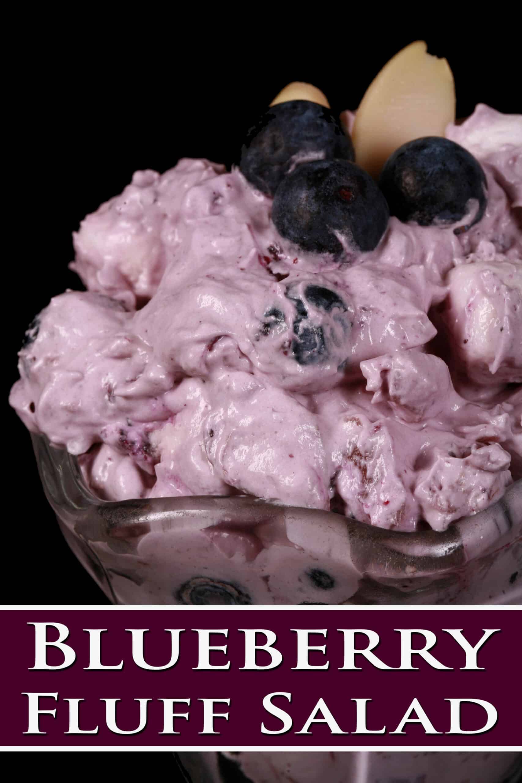A bowl of blueberry and marshmallow fluff salad. Overlaid text says blueberry fluff salad.